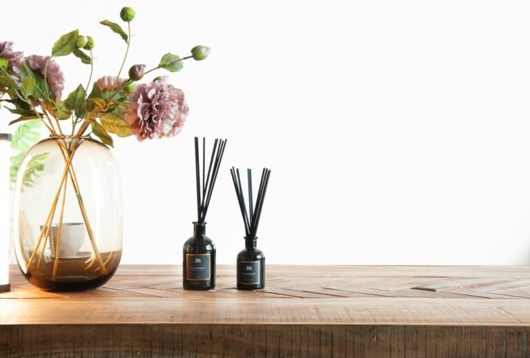 Natural home fragrance setup with dried herbs and essential oil diffuser