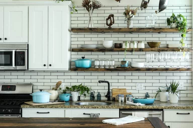 Non toxic cookware and kitchen essentials on a wooden countertop