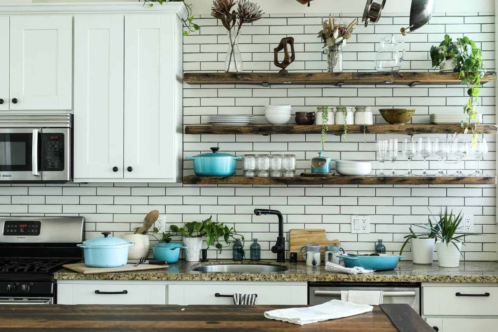 Non toxic cookware and kitchen essentials on a wooden countertop