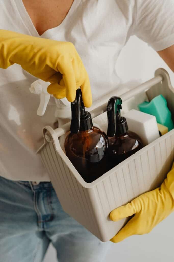 Eco-friendly cleaning supplies in spray bottles and containers.
