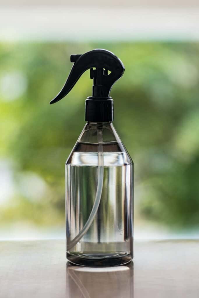 Reusable glass spray bottle with black trigger for eco-friendly cleaning.